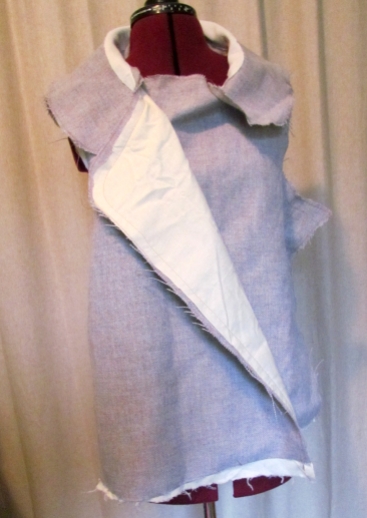 The jacket shell with muslin interllining, attached to the under collar.